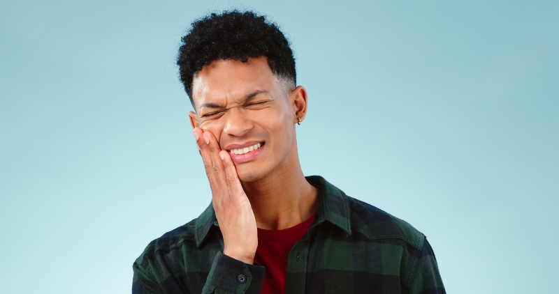 Young man in pain & need for emergency dental care in Tempe, AZ