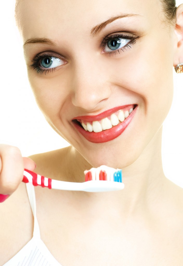 young woman brushing her teeth