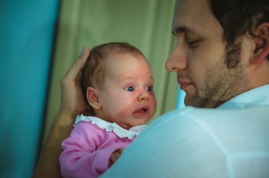 Father is holding a baby