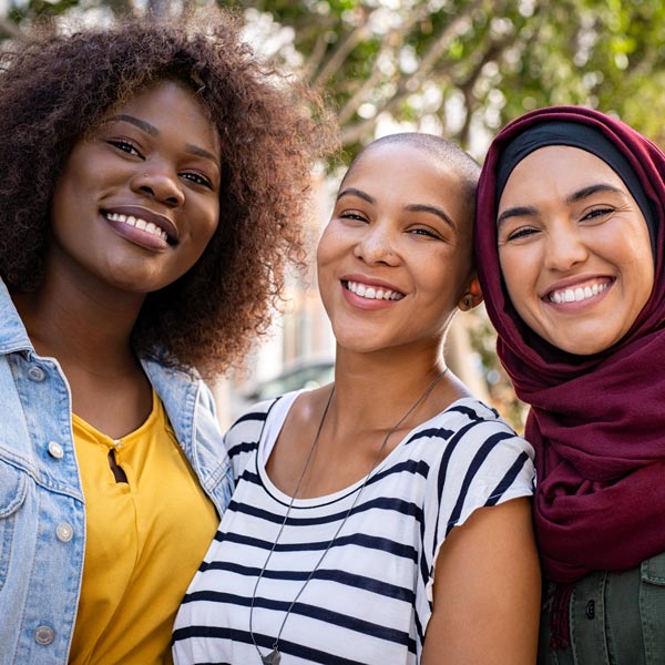 three diverse friends smiling