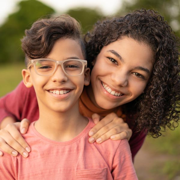 two siblings smiling