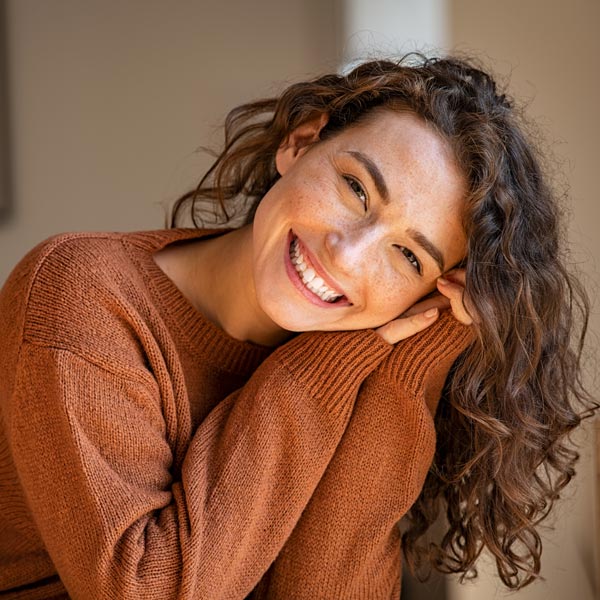 Young woman prevents cavities with routine dental cleanings and exams in Tempe, AZ