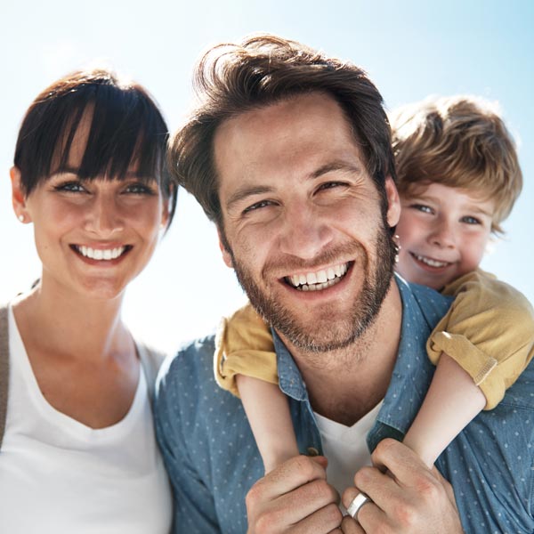 smiling family of three