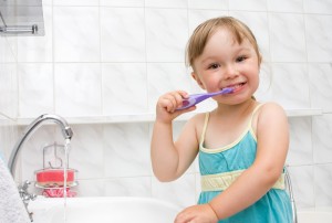 small girl brushing her teeth