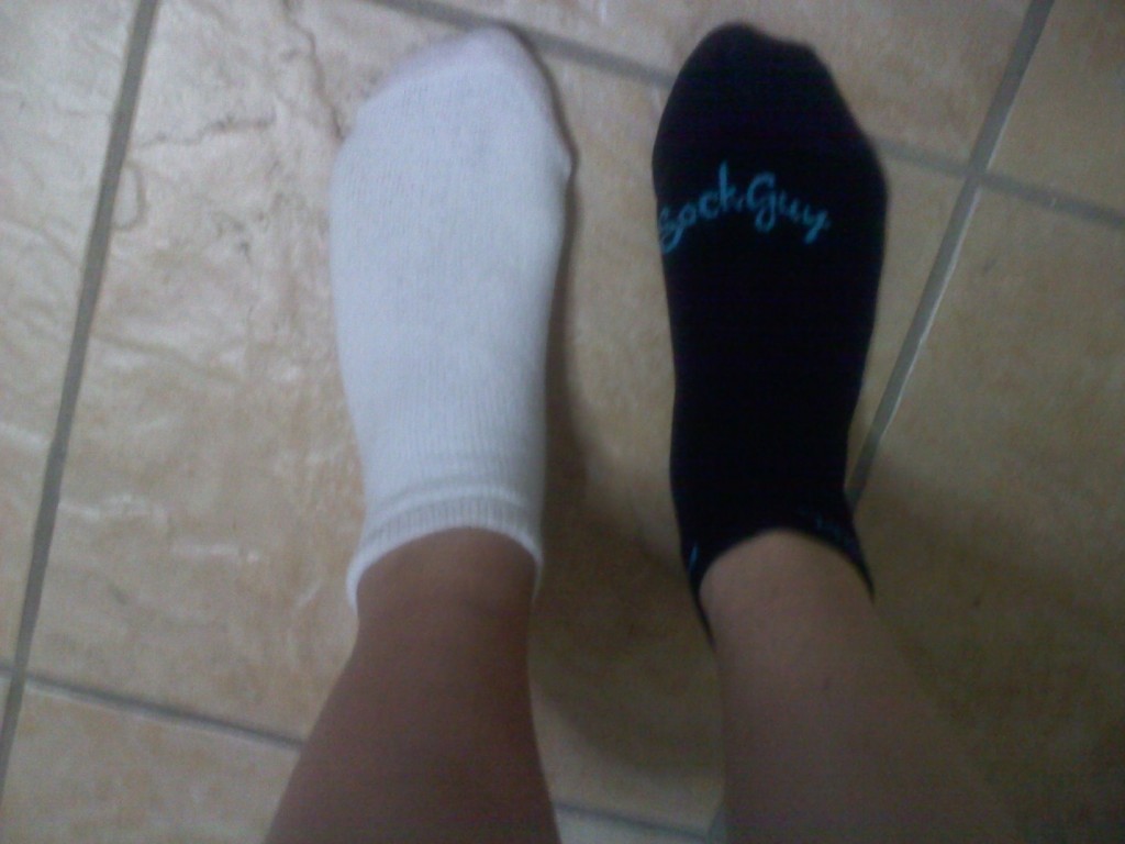 person wearing one black and one white socks