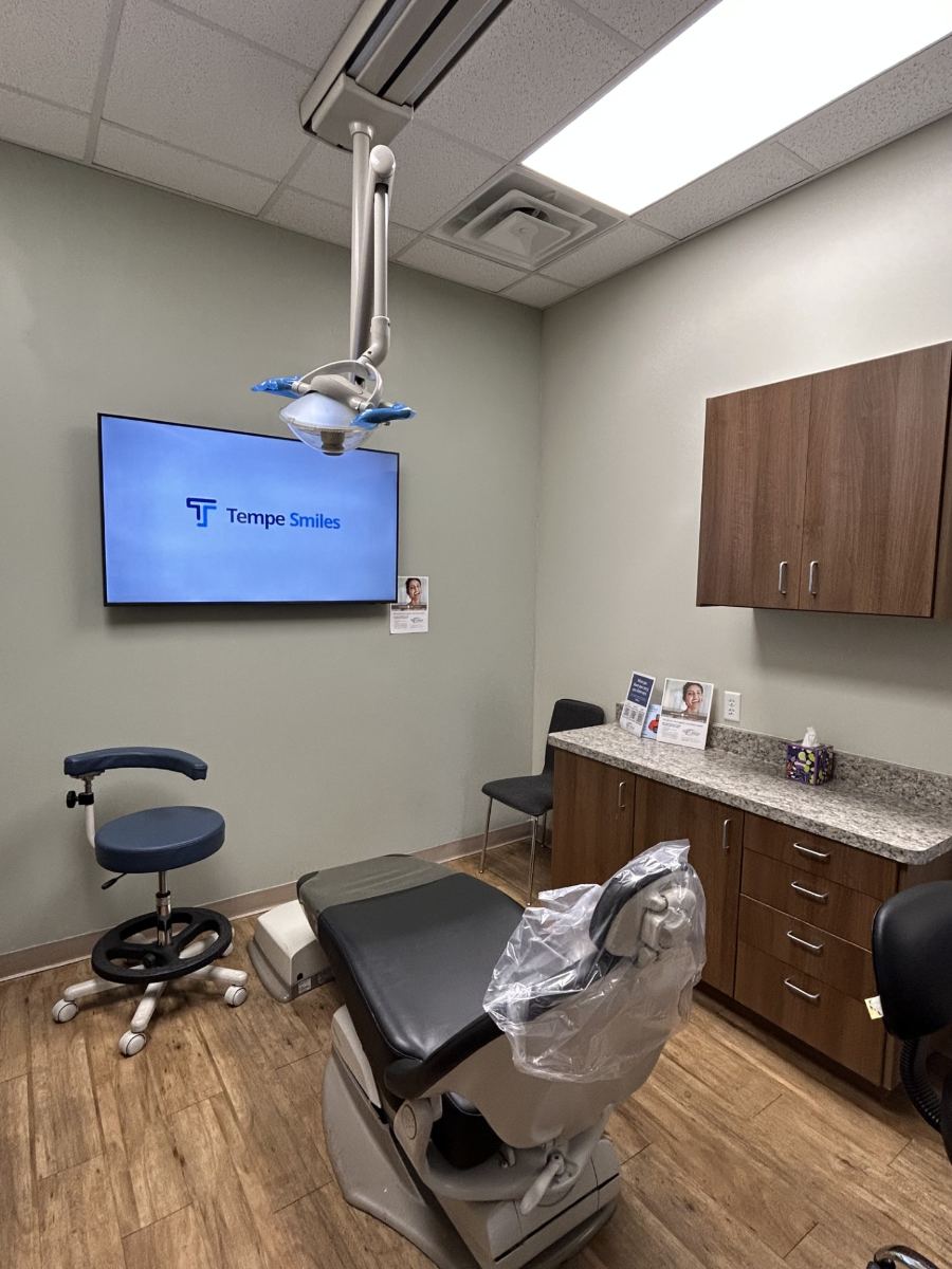 Modern treatment room with ceiling-mounted TV at Tempe Smiles